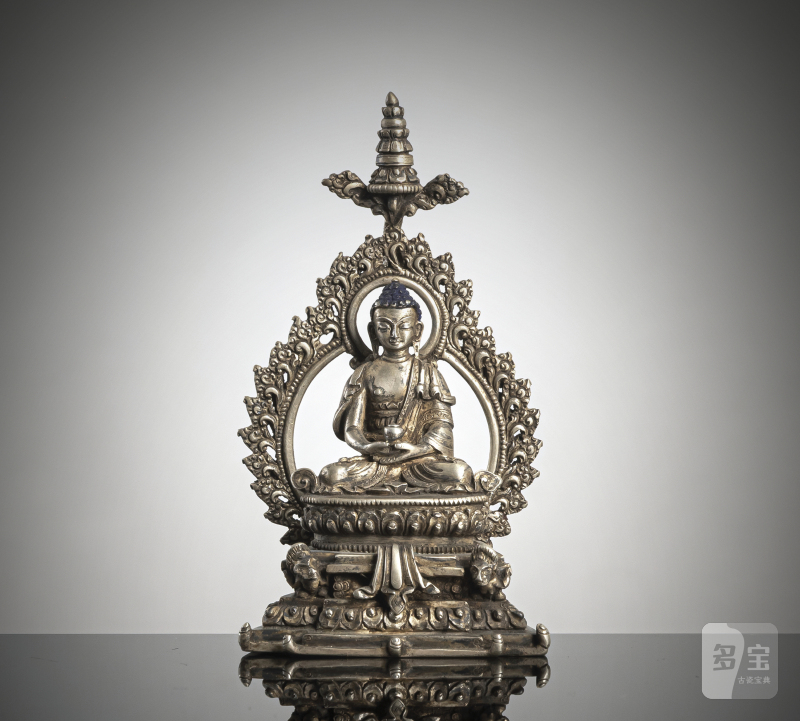 a silver figure of Buddha Shakyamuni